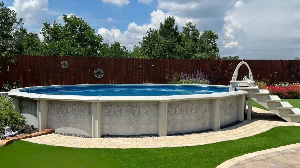 Round above ground pool on a green lawn