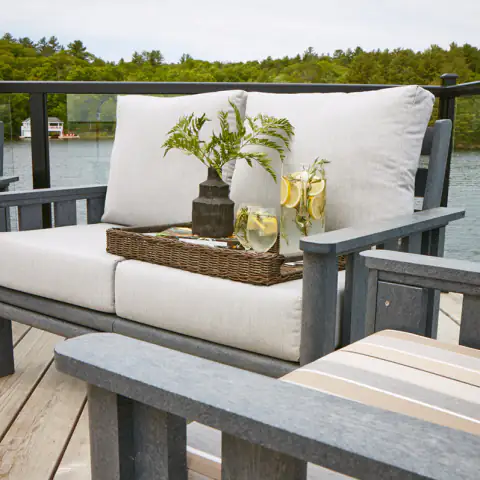 Outdoor sofa with white cushions on a deck
