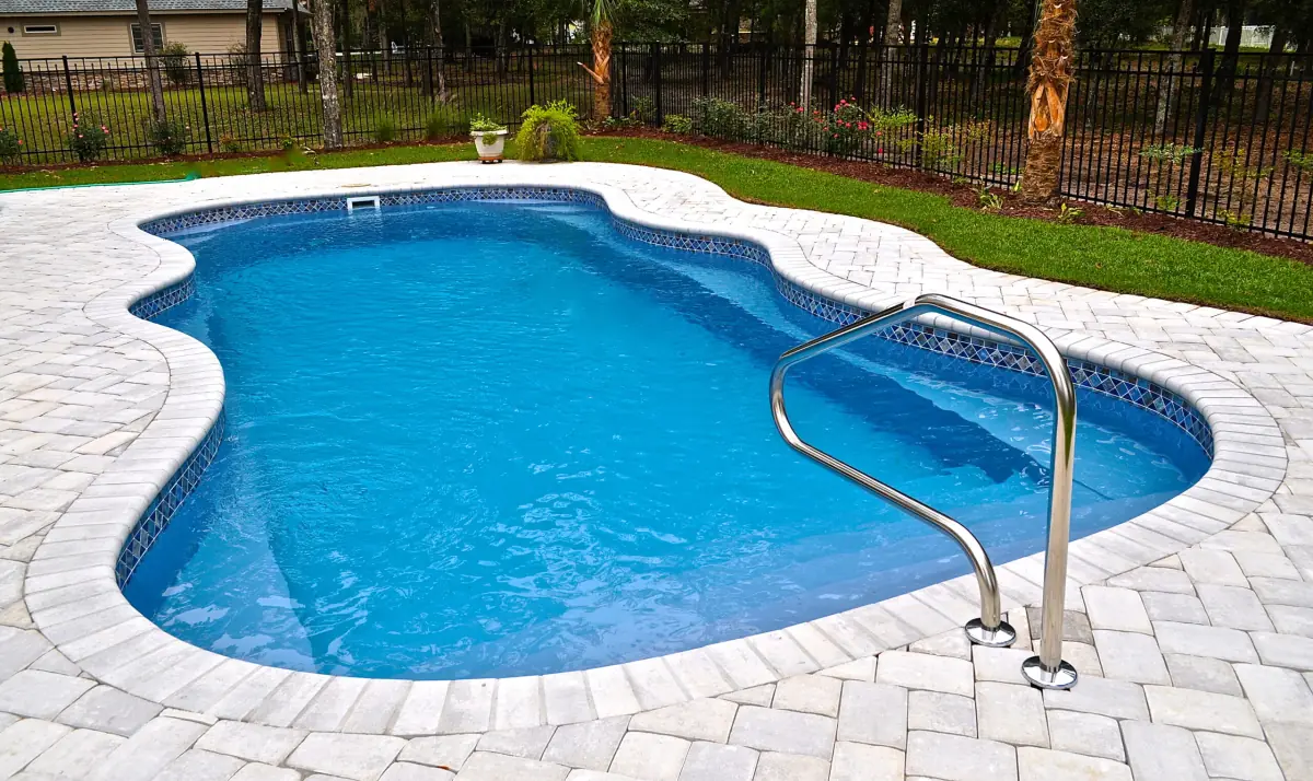 Freeform inground pool with a paver deck