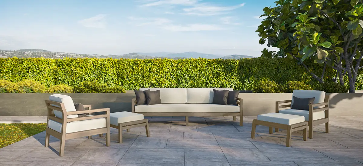 Outdoor sofa and lounge chairs on a stone terrace